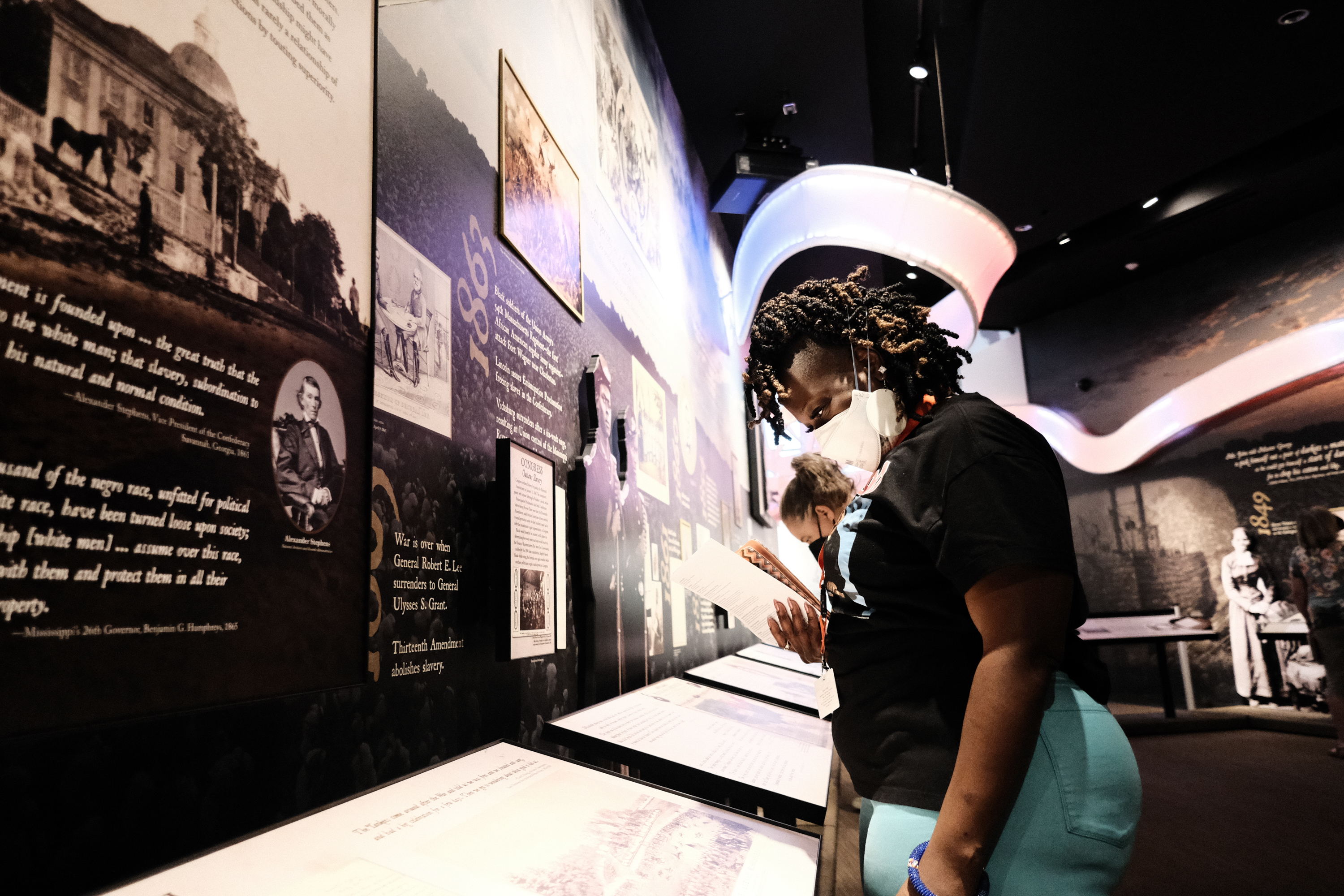 Woman reading information from museum exhibit