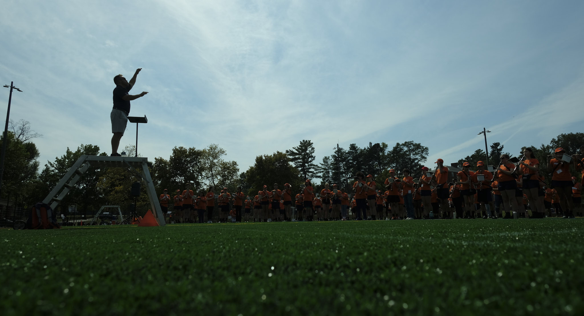 Silhouette of band director at carr's hill field