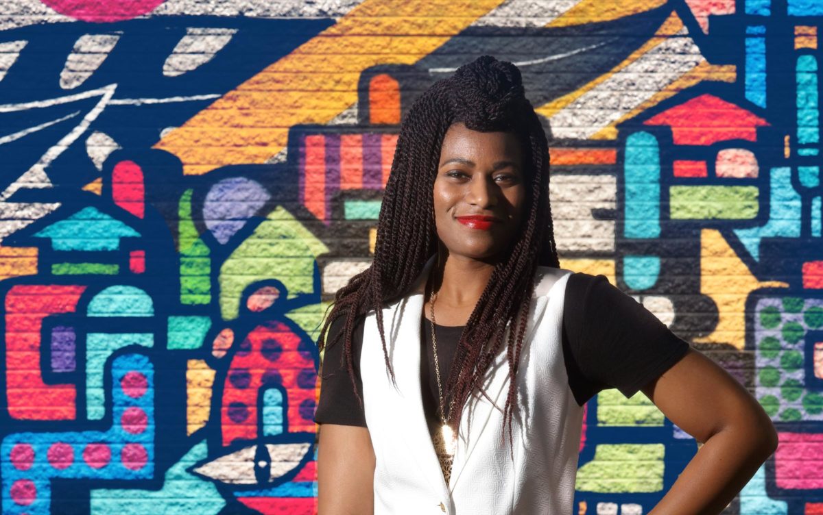 Genevieve standing in front of mural