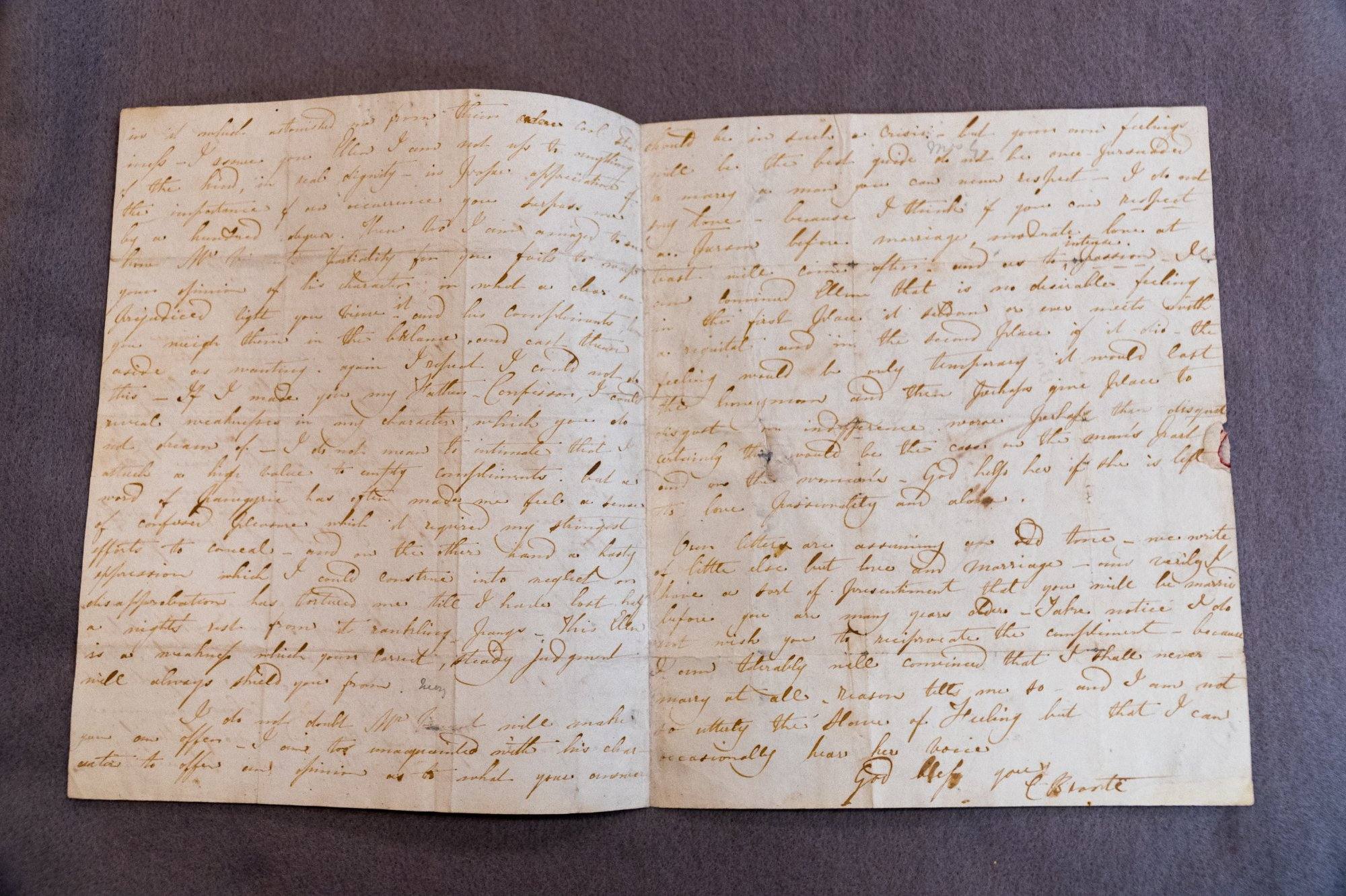Charlotte Bront&euml; autograph letter, open to two pages of dense Victorian handwriting in brown ink