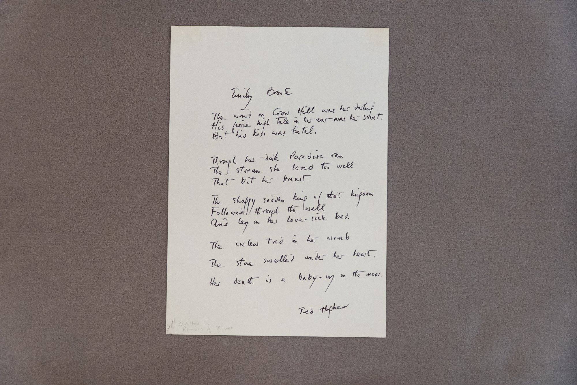 Handwritten poem titled Emily Bront&euml; in bold black ink on white paper, signed Ted Hughes at the bottom
