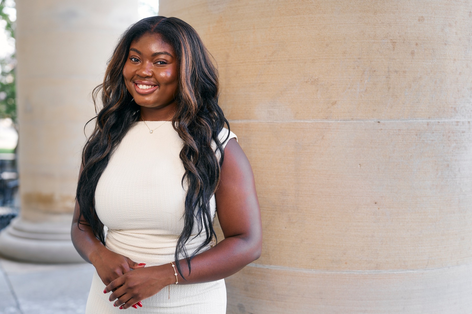 Darnisha Augustin standing beside a column on Grounds.